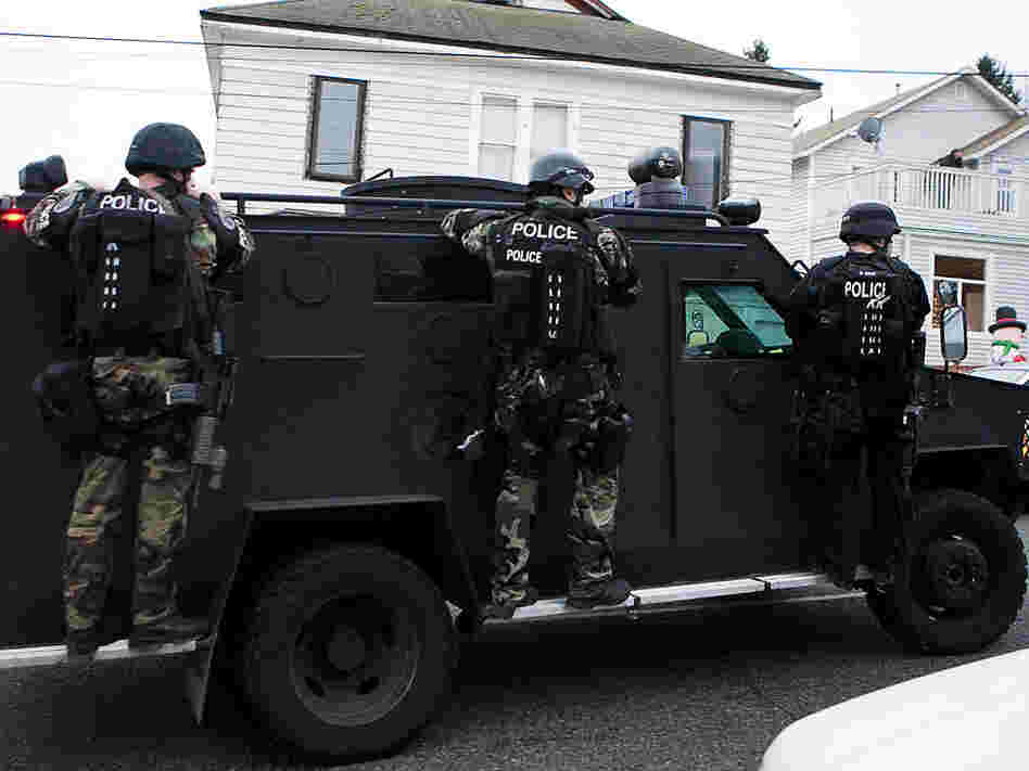 A Seattle police SWAT vehicle leaves the scene of a search for Maurice Clemmons.