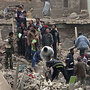 Iraqi security forces and rescuers search for survivors at the site of a bomb attack in Baghdad.
