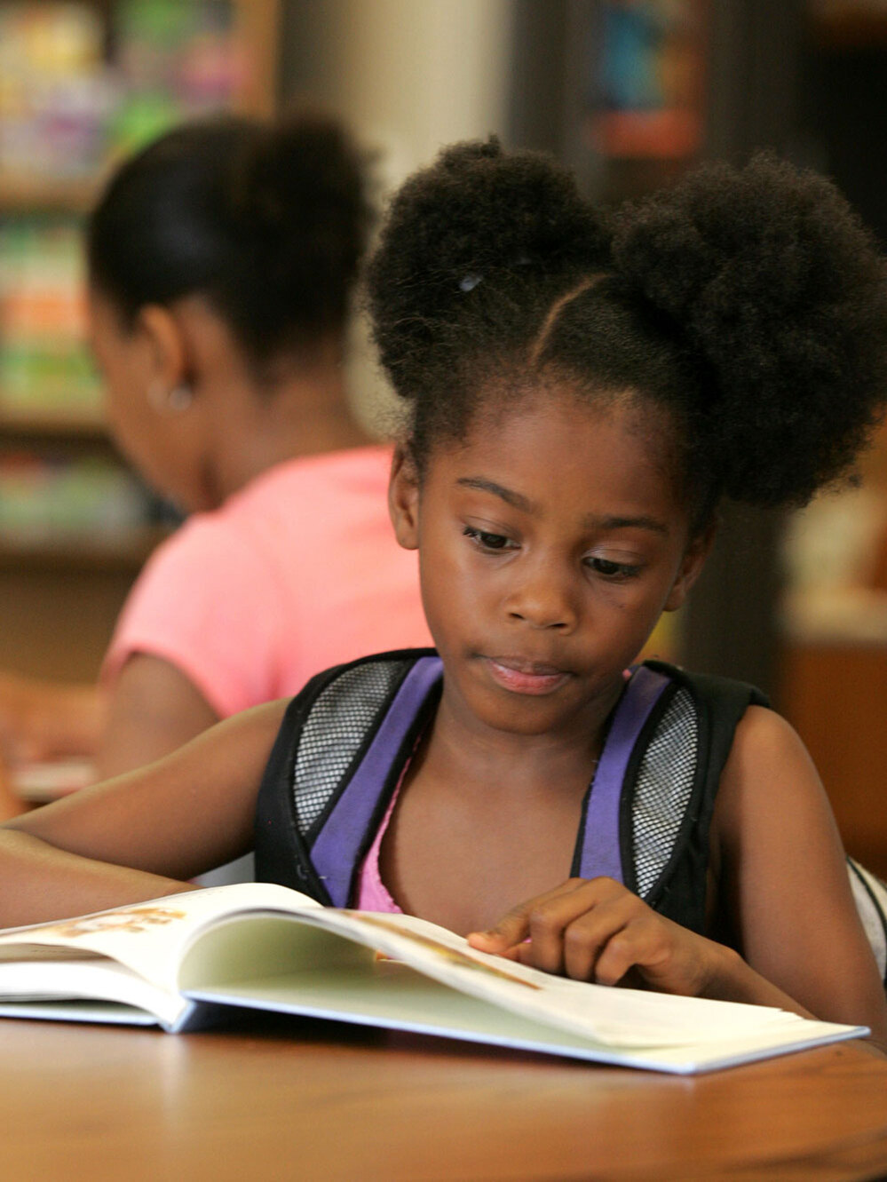 v-My'angel Dooley, 7, reads a book as part of an after-school program in Columbus, Ohio