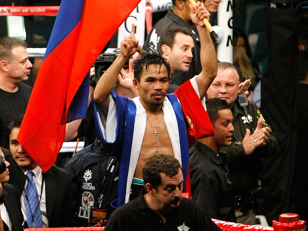 Manny Pacquiao waves the flag of the Philippines as he celebrates his victory over Oscar De La Hoya.