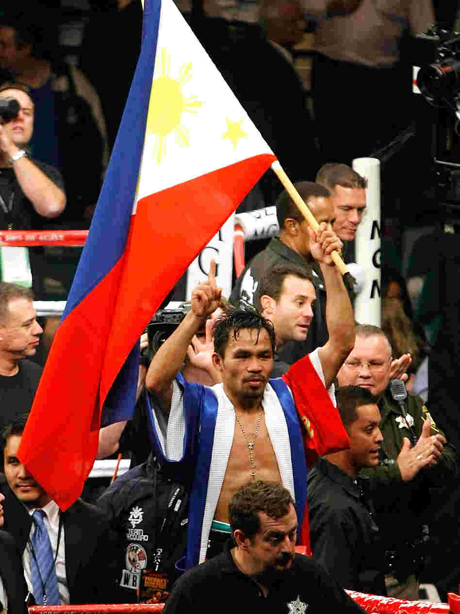 Manny Pacquiao waves the flag of the Philippines as he celebrates his victory over Oscar De La Hoya.