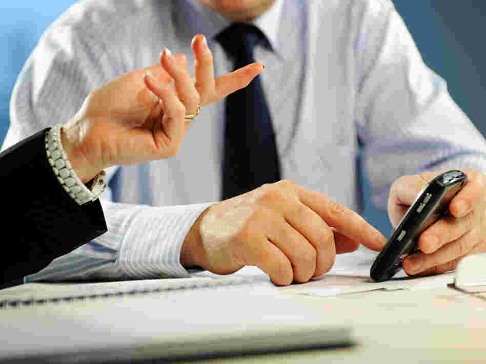A man texts in the workplace