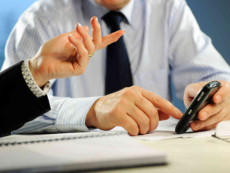 A man texts in the workplace