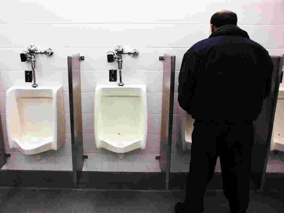 Man at urinal in JFK airport.