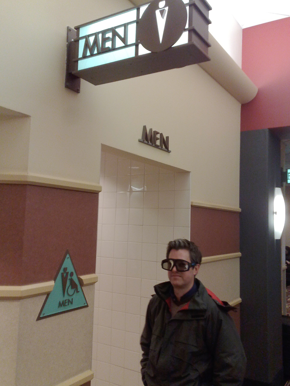 A movie theater patron wears his 3D glasses in the hallway of an IMAX theater before viewing 'Avatar'