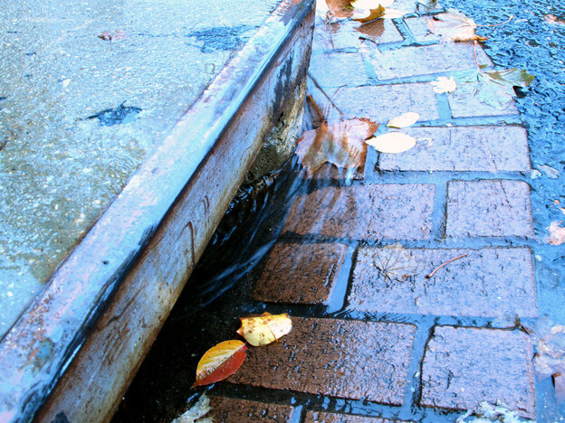 Rain flows into a Washington, D.C. gutter.