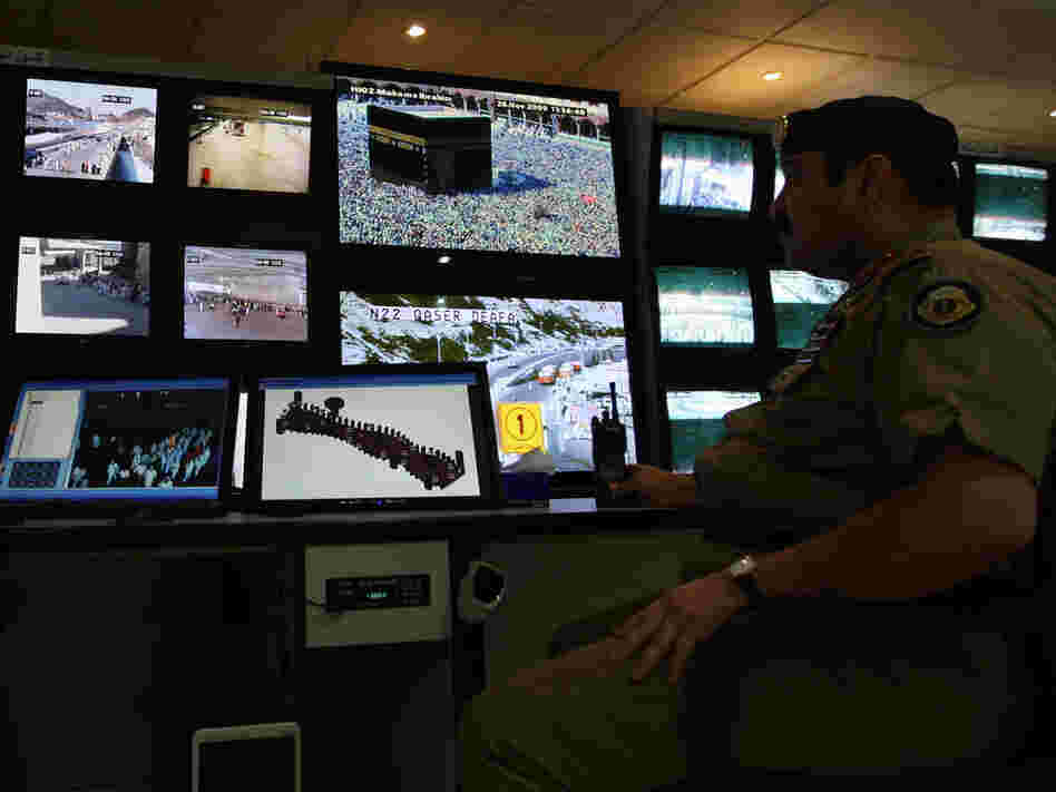 Saudi police officers monitor screens connected to cameras set up at holy places near Mecca.