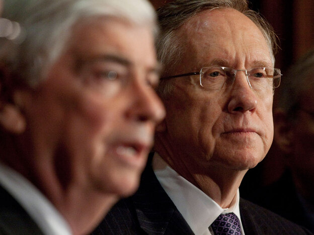 Majority Leader Harry Reid of Nevada listens as Sen. Christopher Dodd speaks