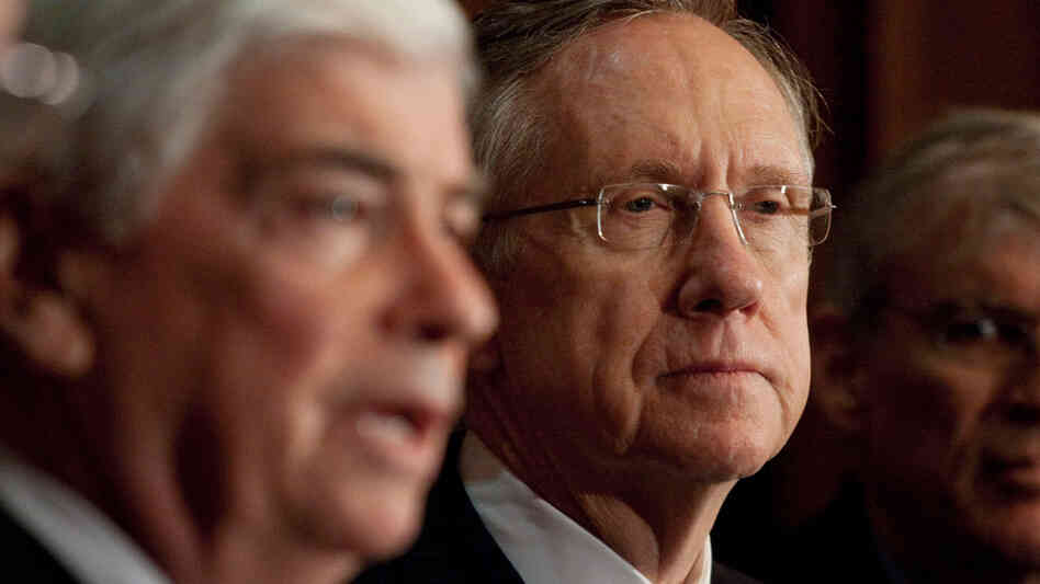 Majority Leader Harry Reid of Nevada listens as Sen. Christopher Dodd speaks