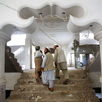 Contractors walk through an apartment complex in Afghanistan.