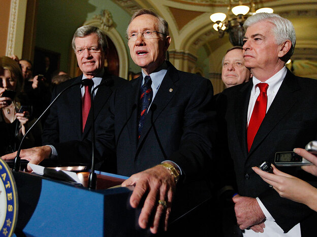 Majority Leader Harry Reid answers questions after the Senate passed the health bill.