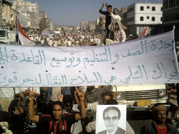 Yemeni protesters hold pro-al-Qaida banners and wave the victory sign.