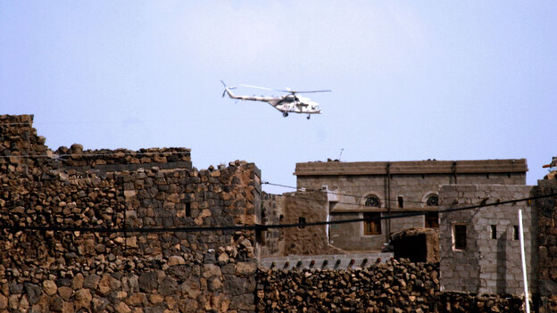 A Yemeni army helicopter flies over  the district of Arhab.