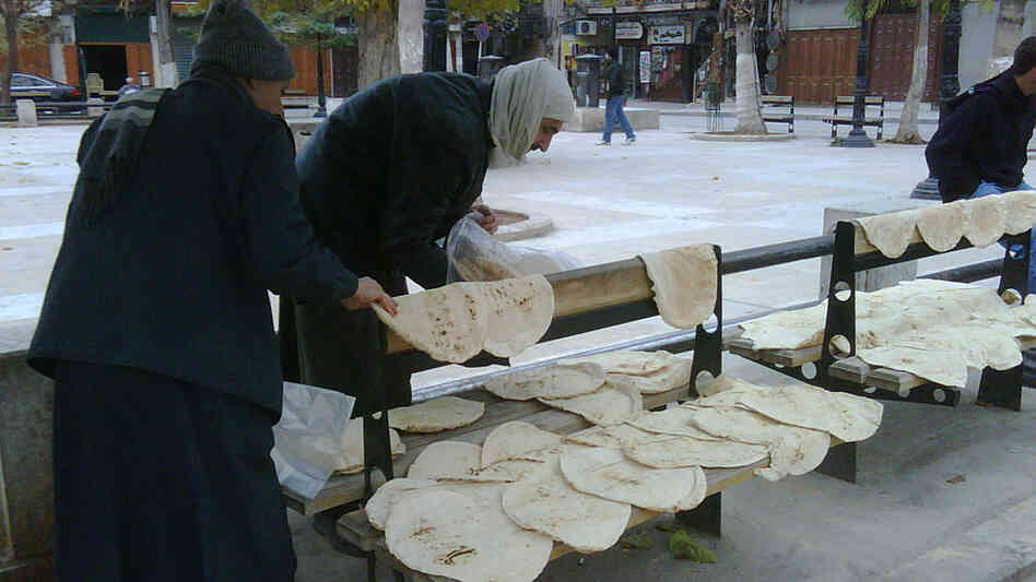 Fresh, hot bread is spread out on any available surface while it cools, a morning ritual in Aleppo. Fresh, hot bread is spread out on any available surface while it cools, a morning ritual in Aleppo.