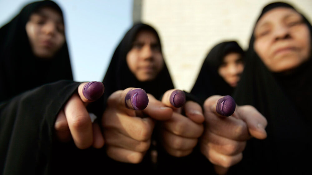 WIDE: Iraqi women show ink-stained fingers after voting in Iraq's 2009 election. Alaa al-Marjani/AP