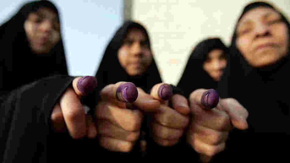 WIDE: Iraqi women show ink-stained fingers after voting in Iraq's 2009 election. Alaa al-Marjani/AP