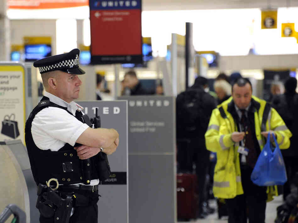 A British police officer stands guard at Terminal 1 of London's Heathrow Airport.