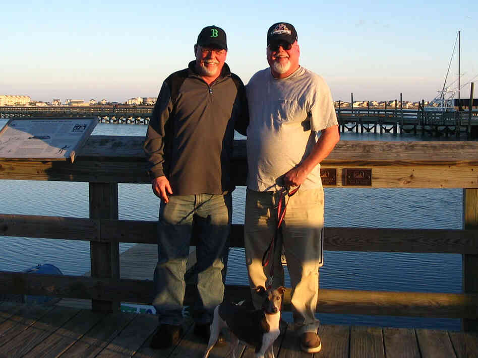 Tim and Paul Daly stand on a dock.