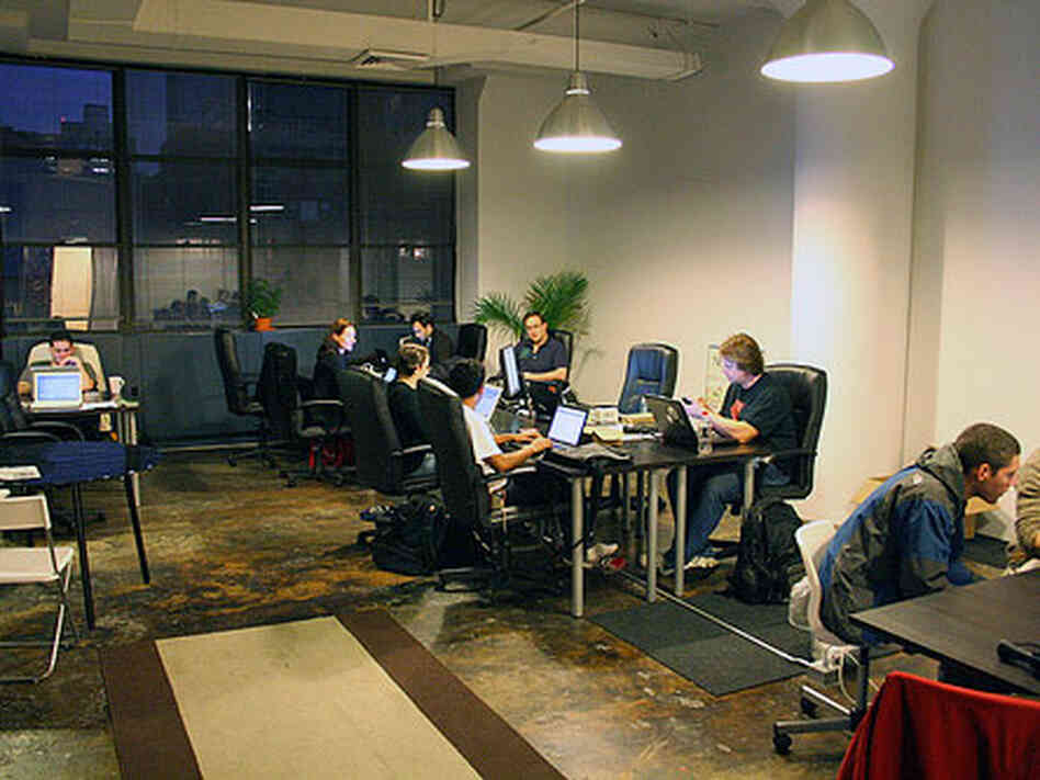 At New Work City patrons work in provided, communal office space. At New Work City patrons work in provided, communal office space.