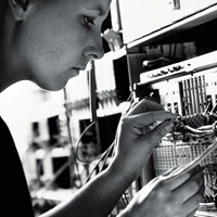 A technician checks a networking cable.