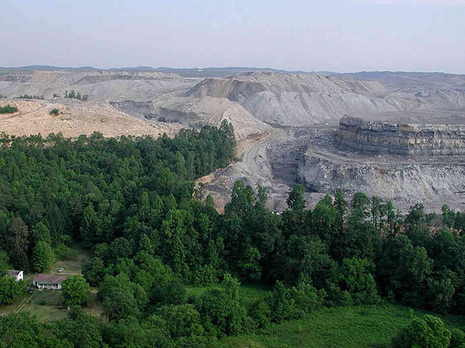 Mountaintop removal coal mining approaches a home. Mountaintop removal coal mining approaches a home.