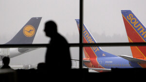 A passenger walks past waiting jets at Seattle-Tacoma International Airport on Jan. 4. Dozens of names have been added to the government's terrorist watch lists and "no fly" list after a failed terrorist attack on Christmas.