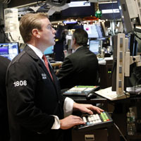 Traders watch market activity at the New York Stock Exchange on Monday.