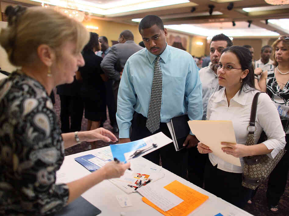 Lionel Longsworth and Linette Rodriguez stop by the Aflac booth during a job fair.