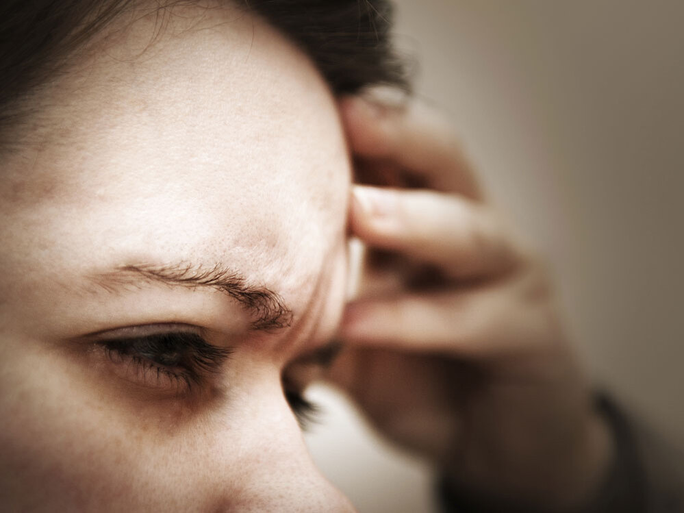 A woman suffering from headache pain.
