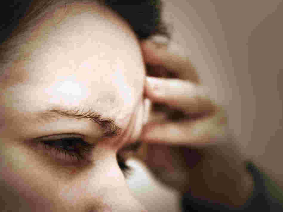 A woman suffering from headache pain.