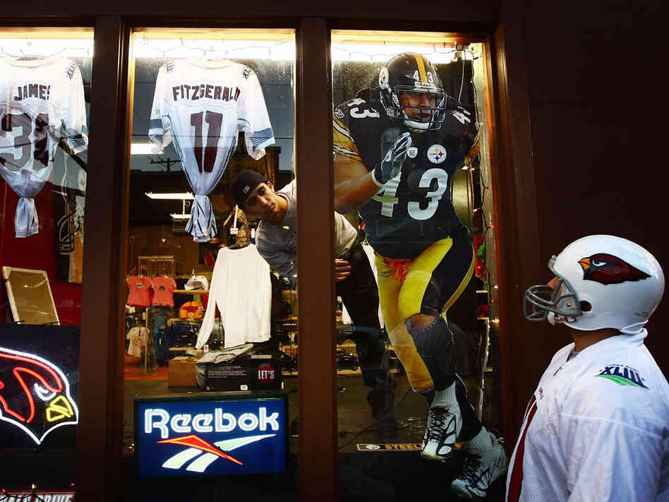 A fan gazes at Super Bowl XLIII merchandise in a Tampa, Fla. store window.