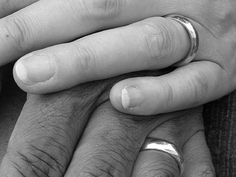 An interracial couple holding hands An interracial couple holding hands