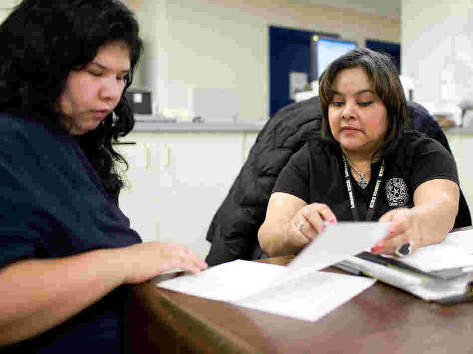 Officer Sylvia Urrutia interviews Dominica Esparza for Lubbock's pre-trial release program.