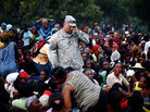 A U.S. Army soldier from the 82nd Airborne Division is surrounded by Haitians. A U.S. Army soldier from the 82nd Airborne Division is surrounded by Haitians.