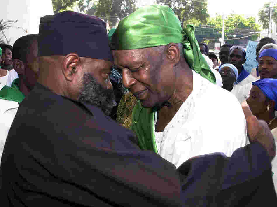 Voodoo priest Max Beauvoir and another man pray during a Voodoo demonstration.
