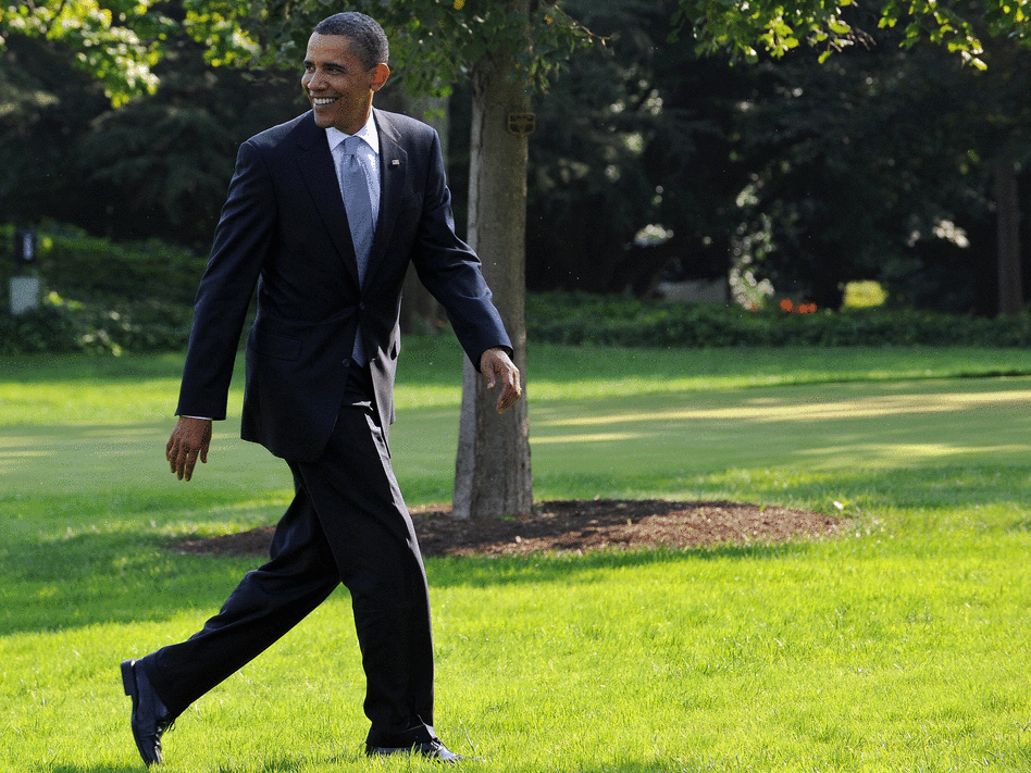 President Obama walks across a lawn