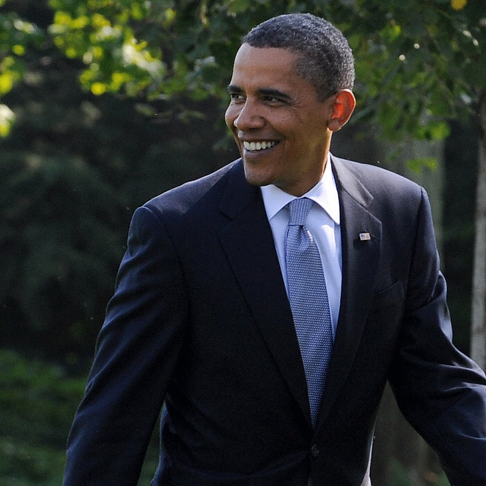 President Obama walks across a lawn