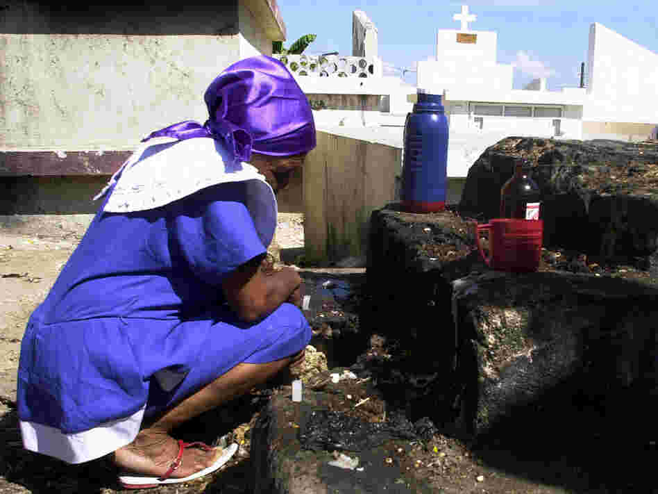 A Haitian woman observes a moment of silence.