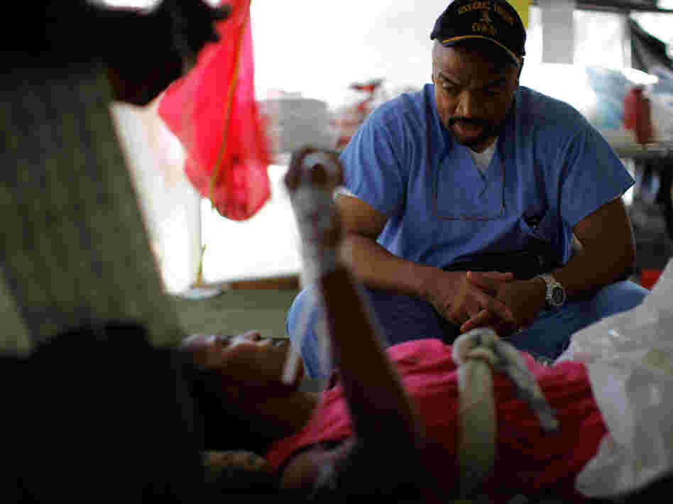 Dr. Henri Ford, a U.S. citizen born in Haiti, speaks in Creole to  an anxious patient.