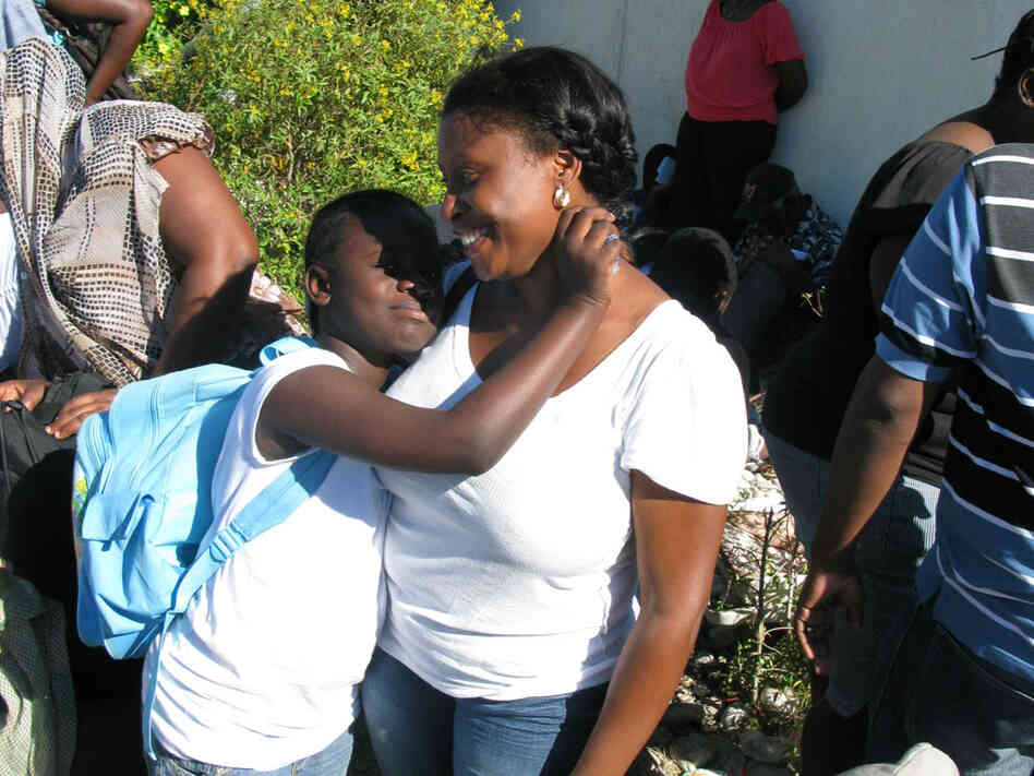 Margalita Belhumer and her daughter, Melissa, 8, stand outside the U.S. Embassy in Port-au-Prince.