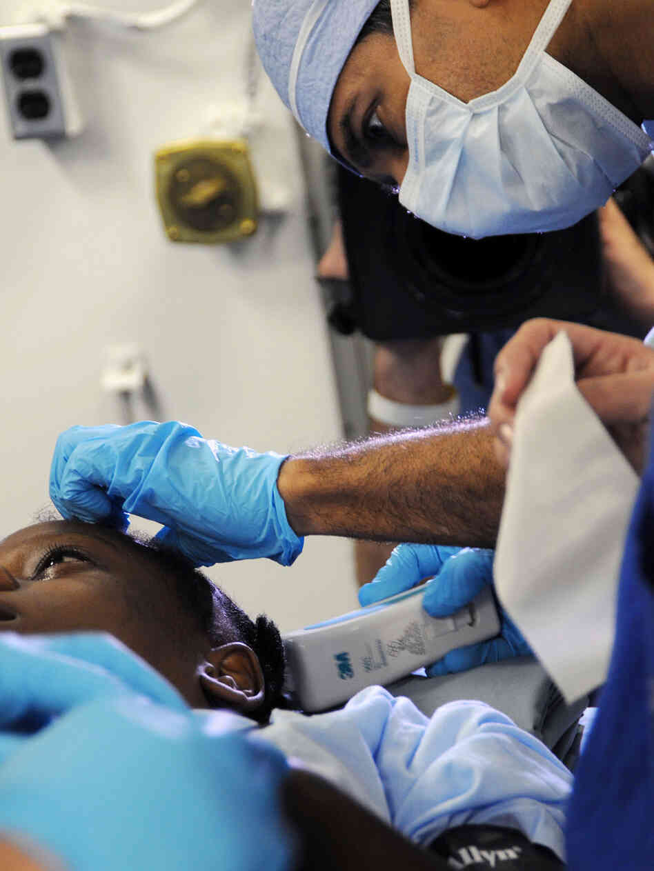 CNN Chief Medical Correspondent Dr. Sanjay Gupta preps a Haitian earthquake survivor for surgery. CNN Chief Medical Correspondent Dr. Sanjay Gupta preps a Haitian earthquake survivor for surgery.