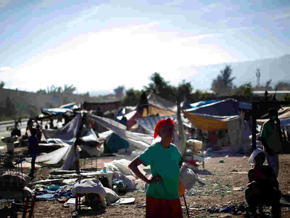 A woman stands near a makeshift refugee camp near downtown Port-au-Prince