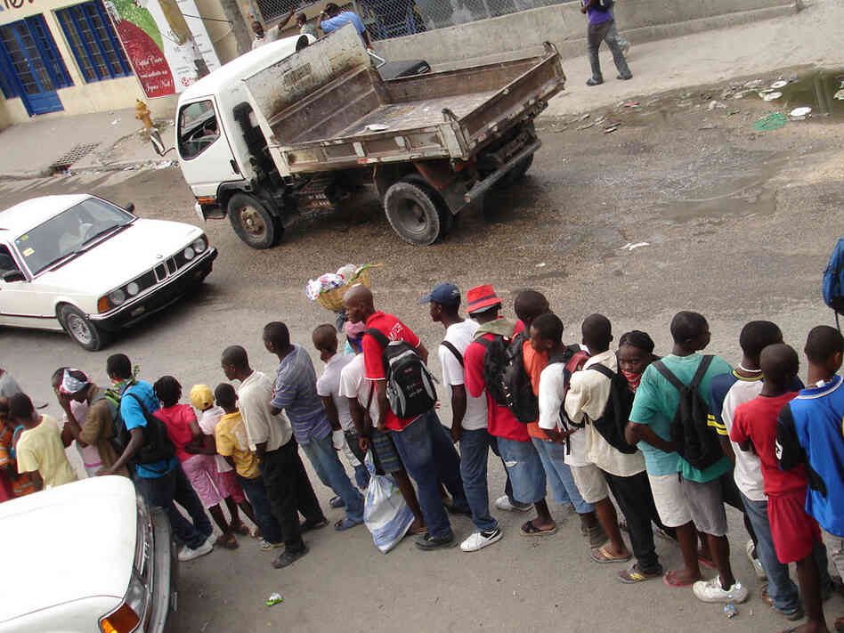 Haitians line up for free food at Muncheez in Petionville, Haiti