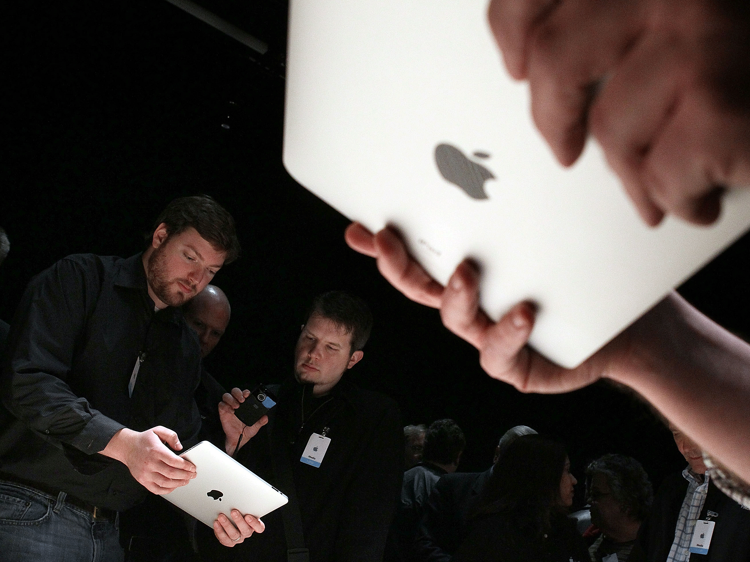 <strong>Will You Be An iPad User?</strong> Event guests play with the new Apple iPad Wednesday during an Apple Special Event at Yerba Buena Center for the Arts in San Francisco. CEO Steve Jobs introduced the company's latest creation, the iPad, a mobile tablet browsing device that's a cross between the iPhone and a MacBook laptop.