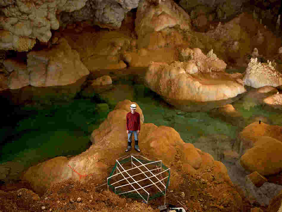 Sixteen-year-old inventor Alexander Kendrick stands in the Lake of the Clouds.