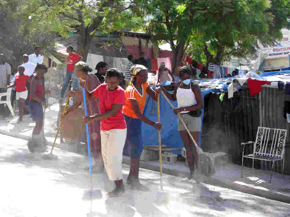 Women sweep the street in an impoverished area outside of Port-au-Prince, Haiti. Women sweep the street in an impoverished area outside of Port-au-Prince, Haiti.