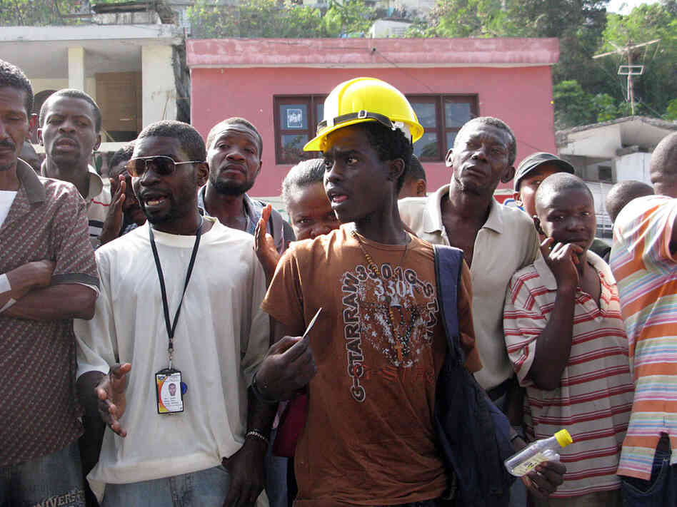 An angry young man shouts at an organizer during food distribution in Port-au-Prince.