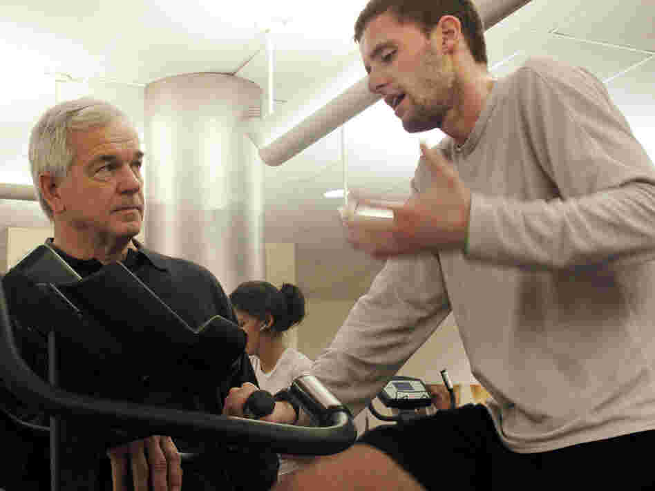 Exercise researcher Bob Karch coaches a man working out on the bike.