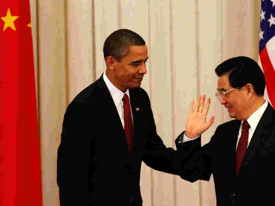 Chinese President Hu Jintao gestures to President Obama after a joint press conference