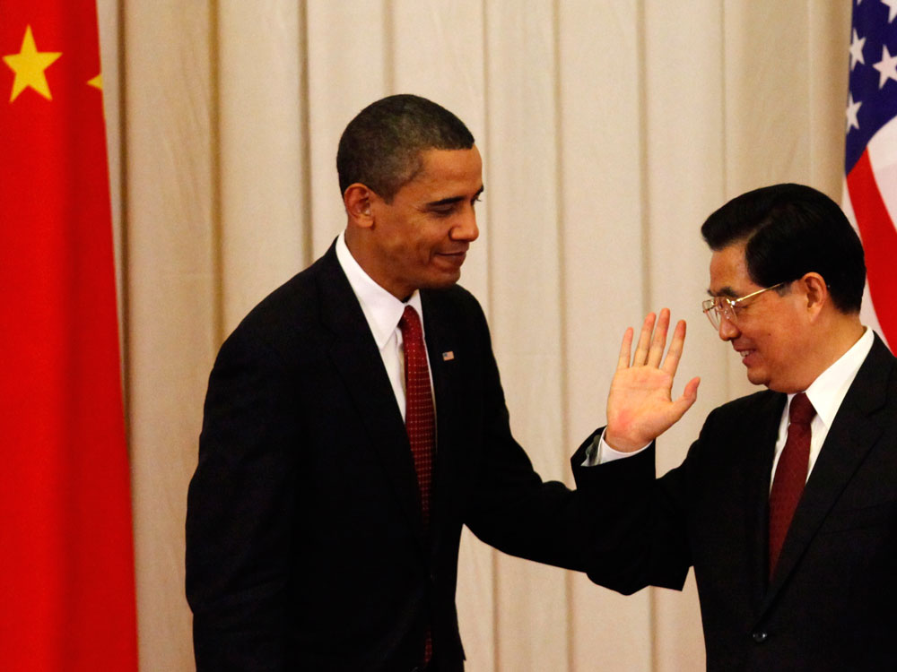 Chinese President Hu Jintao gestures to President Obama after a joint press conference